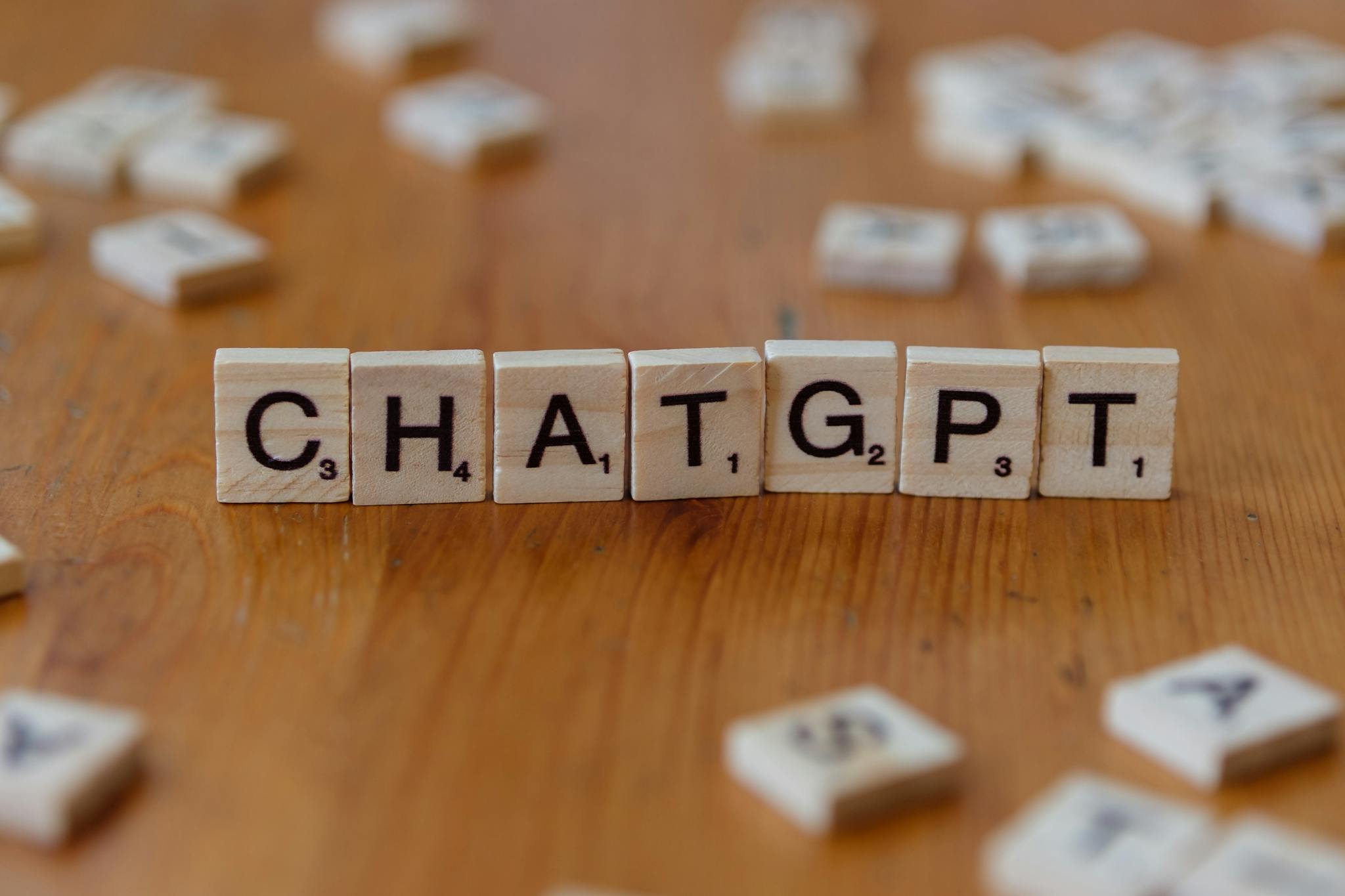 Scrabble Tiles Spelling Chatgpt On Wooden Surface